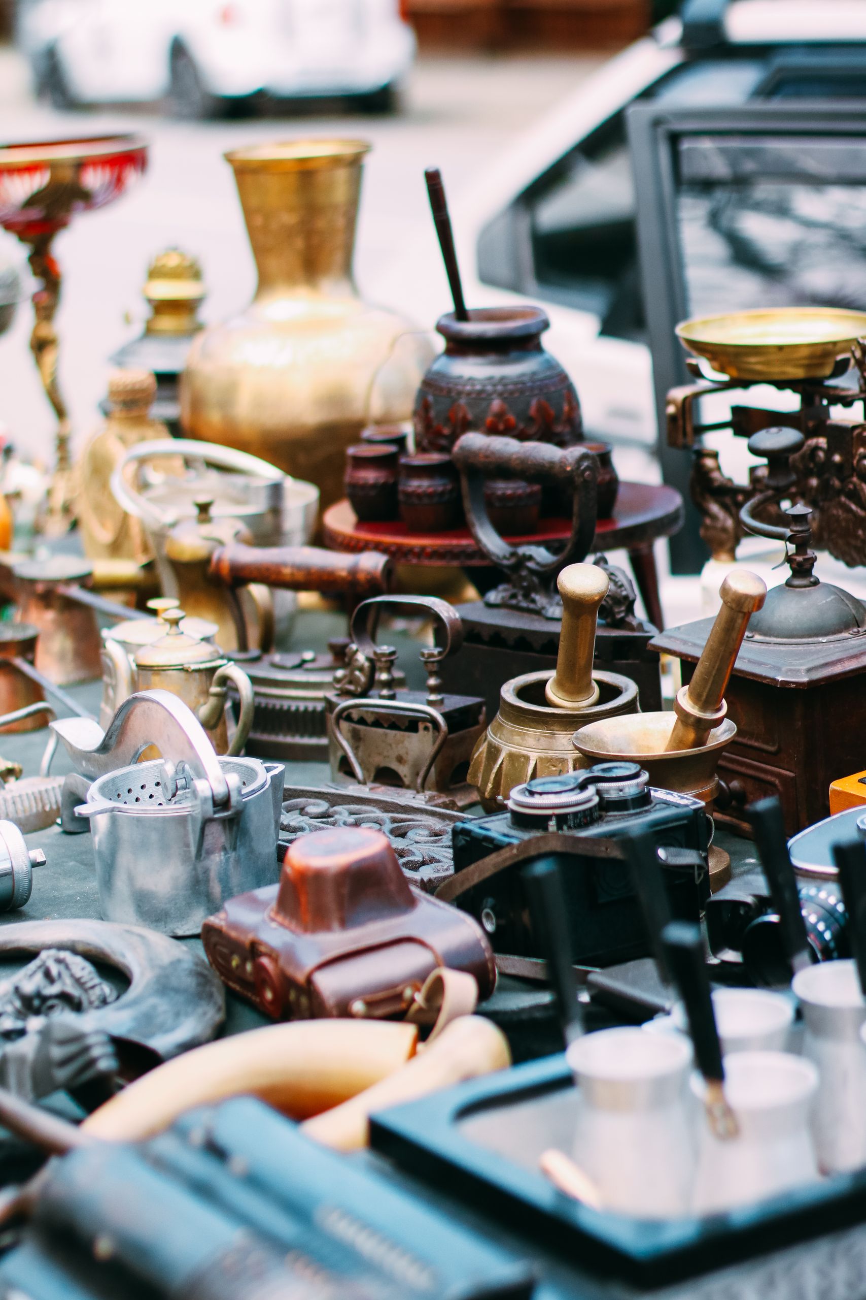 A collection of vintage antiques showcased at an outdoor flea market for eclectic collectors.